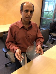 UC Davis food scientist Nitin Nitin with samples of antifouling, antibacterial plastic. The material could be used for packaging and for lining produce bins.